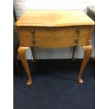 A quarter-veneered oak side table, the moulded top with canted corners above two drawers with shaped