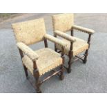 A pair of Carolean style dowel-jointed oak armchairs with studded tapestry upholstery, the arms on