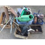 Miscellaneous tools including saws, nails, a Tilley lamp, a garden hose reel, planes, a jack,