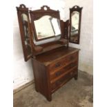 A late Victorian art nouveau satin walnut dressing table, the back with arched bevelled mirror in