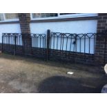 Four wrought iron gates, with square vertical bars beneath zig-zag geometric style friezes,