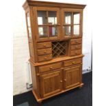 A modern hardwood dresser, with moulded cornice above a pair of glazed mirror back cupboards with