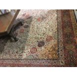 An Arran Wilton carpet woven in the oriental style, having fawn field with central scalloped