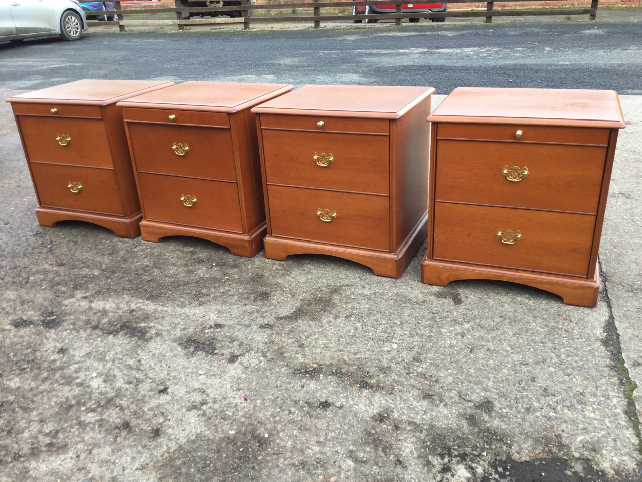Two pairs of mahogany bedside cabinets by Stag, with moulded tops above slides and two drawers