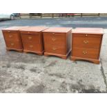 Two pairs of mahogany bedside cabinets by Stag, with moulded tops above slides and two drawers