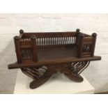 An oriental carved hardwood chair, the rectangular seat framed by gallery spindles in moulded frames