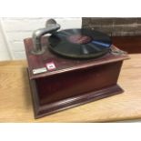 A wind-up gramophone with moulded stained case having fretwork door, the working diaphragm
