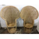 A pair of lotus cane armchairs with wide spade shaped backs above circular seats, raised on