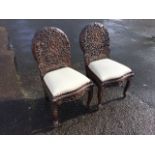 A pair of Victorian Anglo-Indian chairs, the oval backs carved with pierced floral decoration with