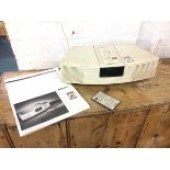 A Bose Wave alarm/radio, complete with instruction manual, remote, etc.