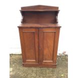 A small nineteenth century mahogany chiffonier, having back with shelf on scrolled supports above