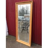 A large contemporary mirror in moulded pine frame. (29in x 65in)