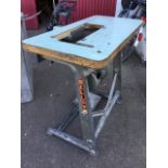 A rectangular sewing machine table with electric motor on cast iron stand. (42in x 20in x 31in)