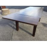 A rectangular hardwood dining table with two spare leaves, raised on square column legs. (95in x