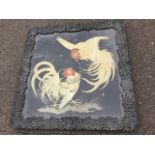 A late nineteenth century square Japanese silwork panel embroidered with two fighting cocks, in