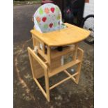 A childs high chair with sliding tray on stand, the detachable seat with cushion and straps.