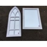 A contemporary mirror with rectangular bevelled plate in white moulded frame having foliate scrolled