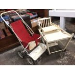 A painted childs high chair with spindle back and swinging feeding tray, folding into a play seat