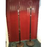 A mahogany standard lamp with tapering column on circular moulded base with three bun feet; and