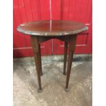 An oval mahogany occasional table, the moulded top with gadroon carved edge above shaped aprons,