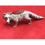 A silver plated fox pin cushion, with red ruby eyes and raised cushioned back. (1in)