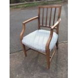 A nineteenth century country elm armchair, the back with four moulded spindles above shaped arms and