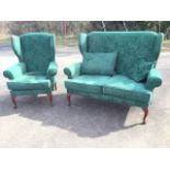 A cottage style wingback sofa & armchair, with loose cushions and padded arms above sprung seats,