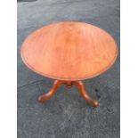An oval Victorian mahogany loo table, the moulded tip-top on turned column with tripartite legs on