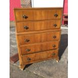A 50s Lebus walnut chest five drawers mounted with brass scrolled handles, raised on shaped