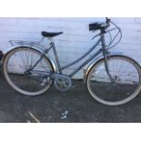 A French Peugeot tradition bicycle with shaped seat, pannier rack, chain guard, three gears, duo-