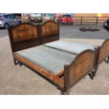 A pair of Edwardian walnut beds, the arched headboards & tailboards with quarter veneered burr