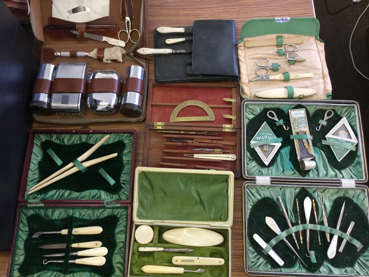 Seven cased sets of implements - sewing, manicure, geometry drawing, gents, etc., mainly incomplete.