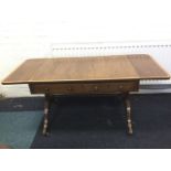 A nineteenth century mahogany sofa table, the crossbanded top with rounded drop-ends above a