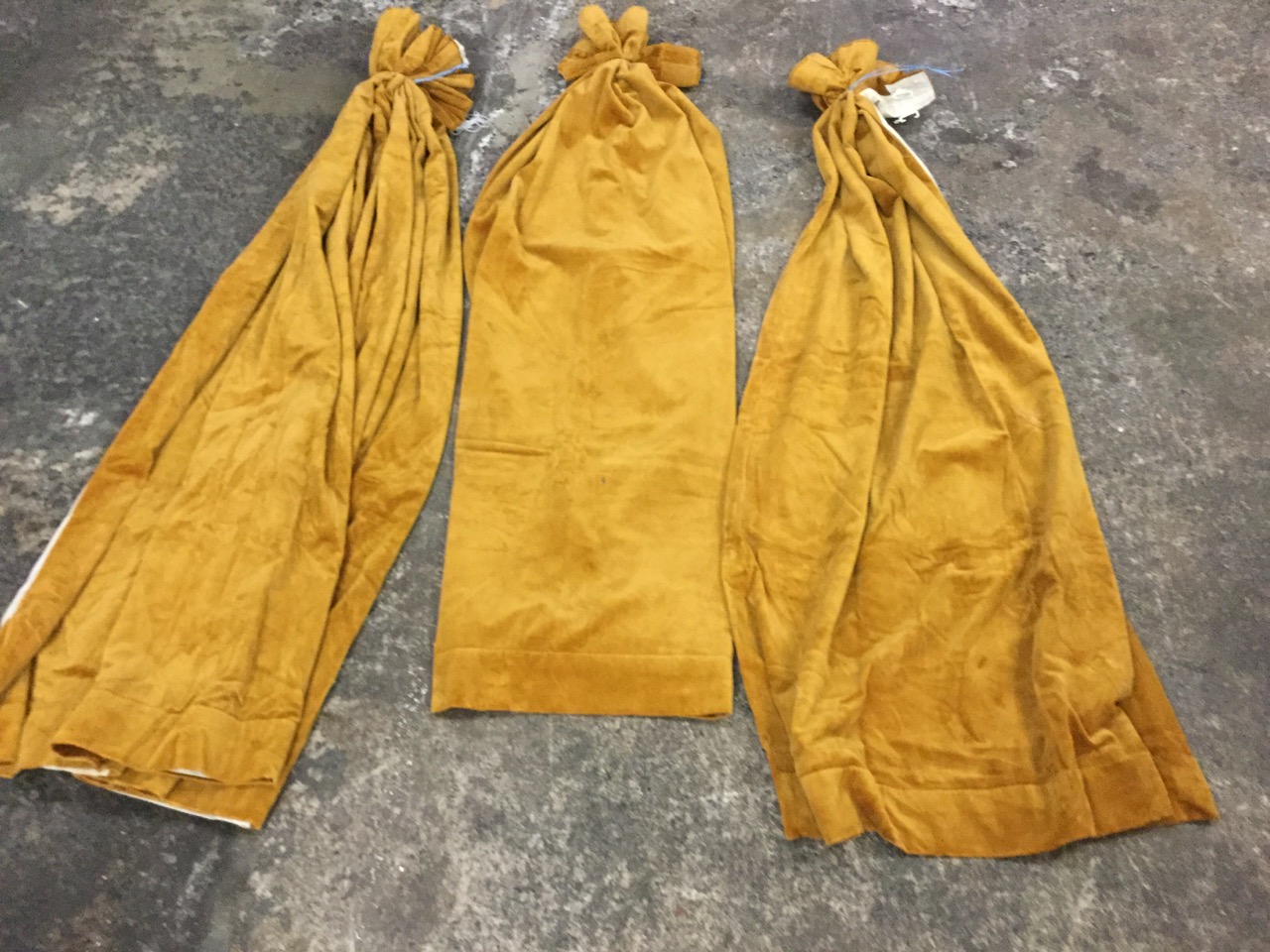 A set of three 5ft lined gold velour curtains. (60in) (3)