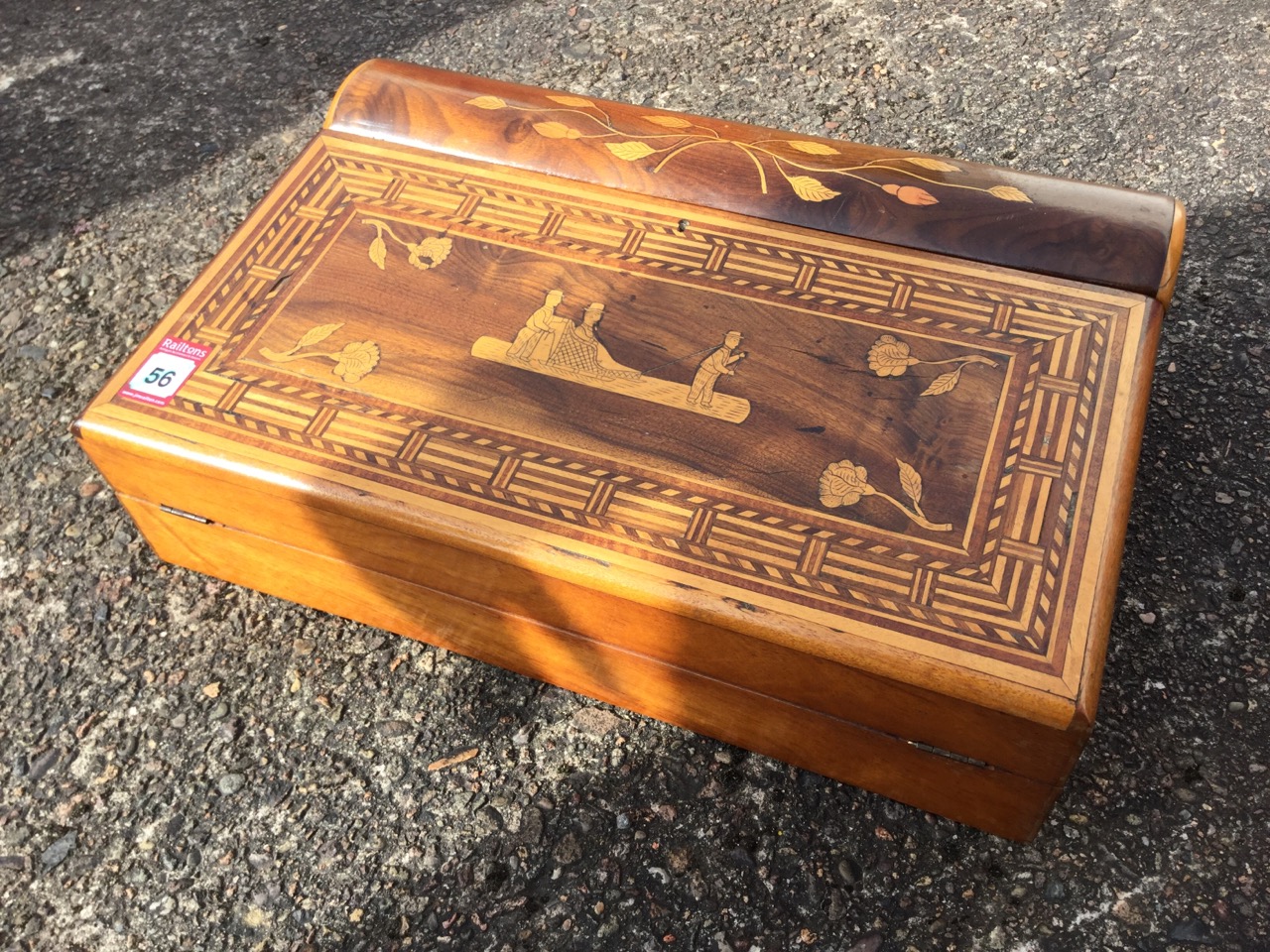 An inlaid lap desk with naive inlay framed by geometric border to fold-out slope, the interior