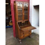 A 30s oak bureau bookcase, the top with astragal glazed doors in moulded frames, above a fallfront