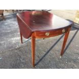 A nineteenth century oval mahogany pembroke table, with two crescent shaped drop-leaves, the