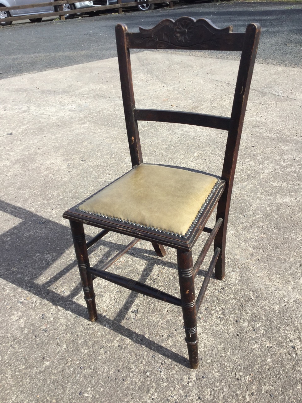 A leather upholstered chair with brass studding, the back rail carved with a flowerhead, raised on - Image 2 of 3