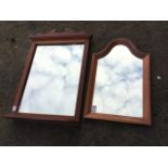 A mahogany framed mirror with shaped crest above a rectangular plate with shelf below; and another