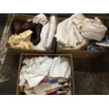 Three boxes of textiles including a wedding dress, embroidery, fur gloves, curtains, printed cotton,