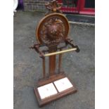 A Victorian cast iron stickstand with Victory label below circular pierced panel having ribbon