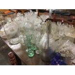 A quantity of glass including vases, fruit bowls, comports, decanters & stoppers, drinking