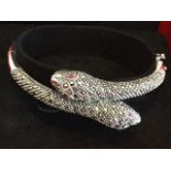 A cased silver & marcasite set snake bangle, the oval hinged pieces with finely modelled