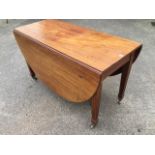 An Edwardian mahogany drop-leaf dining table, the top with twin moulded edge having rounded ends,