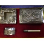 A cased eastern silver smoking set with cigarette box, lighter, ashtray and holder, the pieces