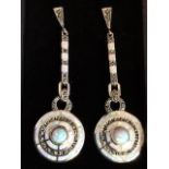A pair of deco style silver, opal and marcasite mounted drop earrings, having circular shield