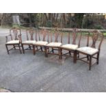 A set of six Hepplewhite style mahogany dining chairs including one carver, with arched backs