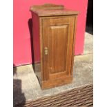A Victorian walnut pot cupboard with shaped upstand to moulded top above a fielded panelled door,