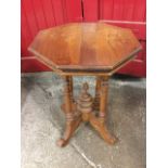 An octagonal hardwood lamp table, the moulded top above a lipped frieze raised on four turned column