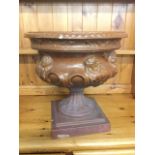 A Victorian slat glazed stoneware urn, having lozenge moulded rim above a cistern embossed with